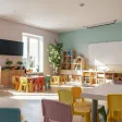 A childcare classroom with small tables and chairs
