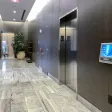 A building lobby with elevators and a polished floor