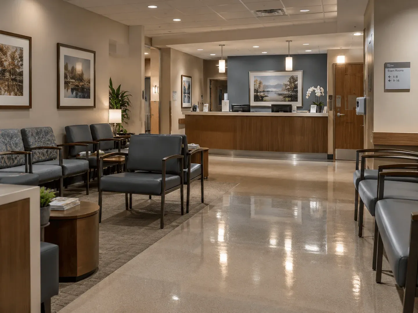 A clean medical waiting room with empty chairs, a polished floor and a reception desk, photographed after hours