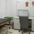 A clinical treatment room with an examination table