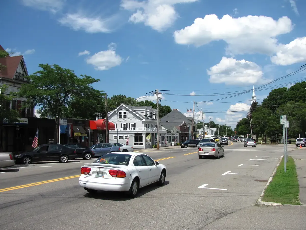 Shops and clapboard buildings along South Street in the centre of Wrentham on a sunny day